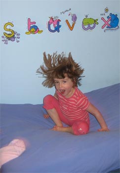 Elinor bouncing on bed.