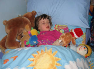 Stringbean in bed with her cuddlies